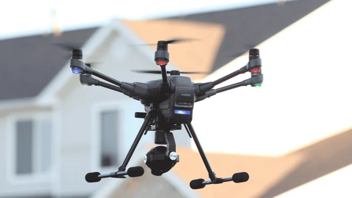 Drone flying in an urban area between houses