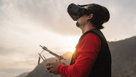 Drone operator flying drone far away from him